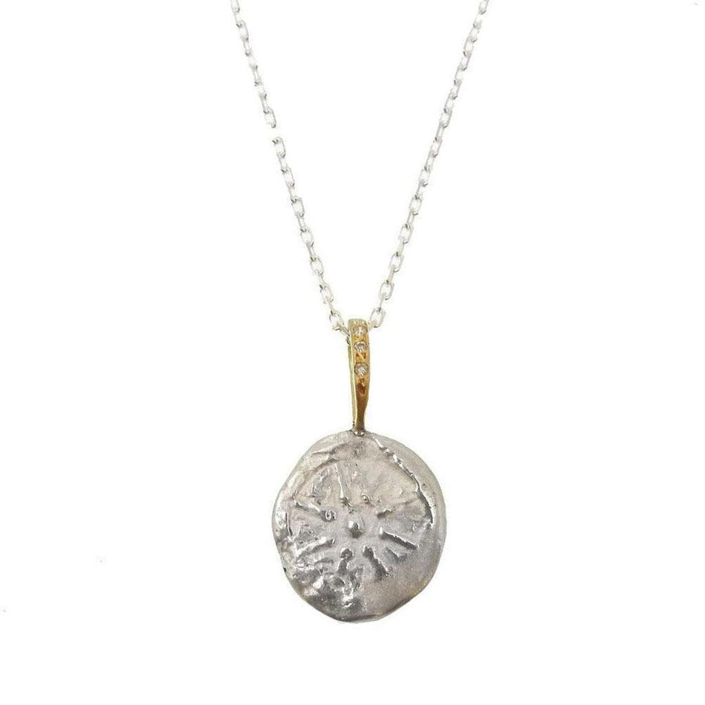 Silver disc pendant necklace with gold accents and tiny diamonds, featuring a star design.