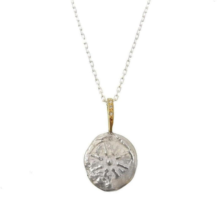 Silver disc pendant necklace with gold accents and tiny diamonds, featuring a star design.