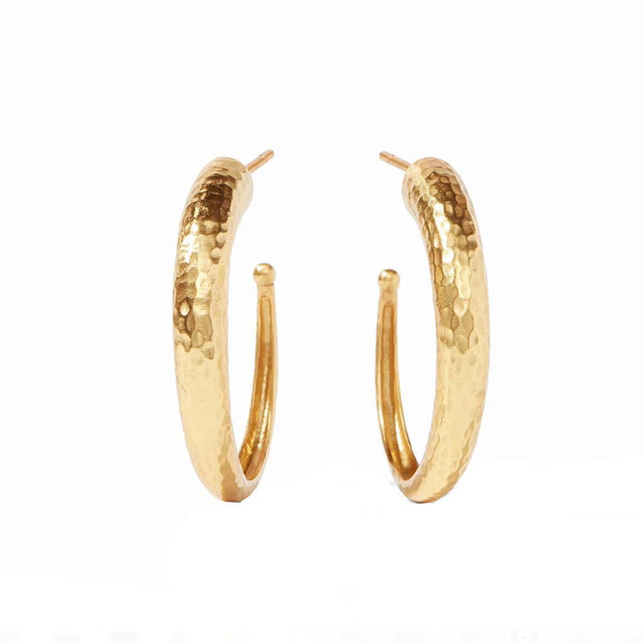 Gold hammered hoop earrings on white background