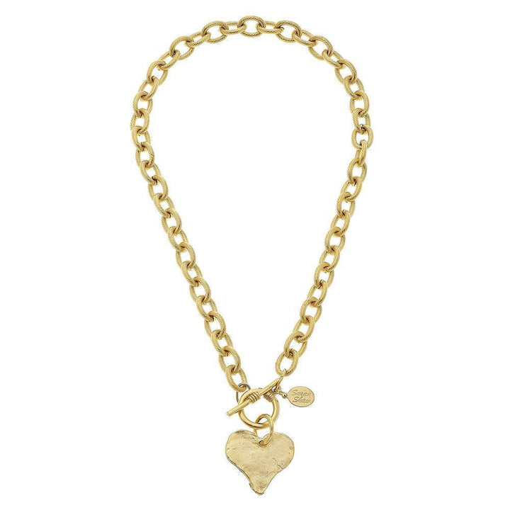 Gold toggle necklace featuring a textured heart charm and a thick chain.