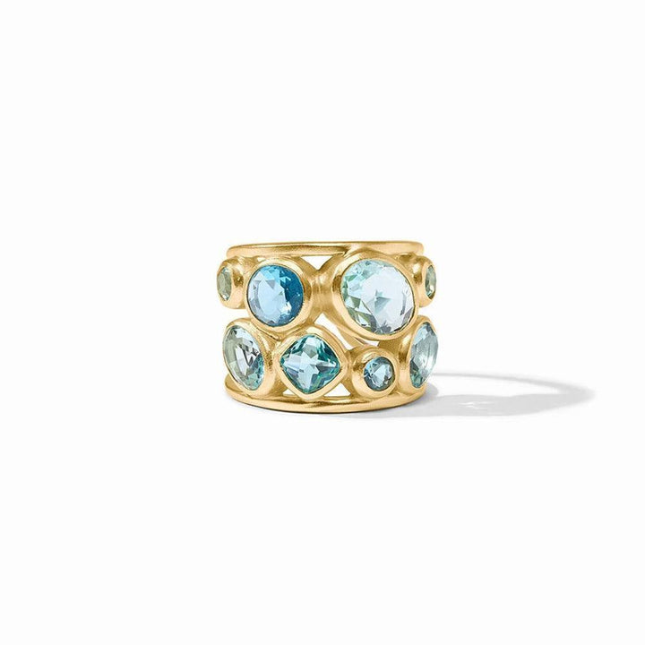 Gold statement ring featuring rows of blue gemstones;  faceted and cabochon cuts.