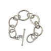 Silver link bracelet with hammered texture and toggle clasp.