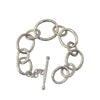Silver link bracelet with hammered texture and toggle clasp.