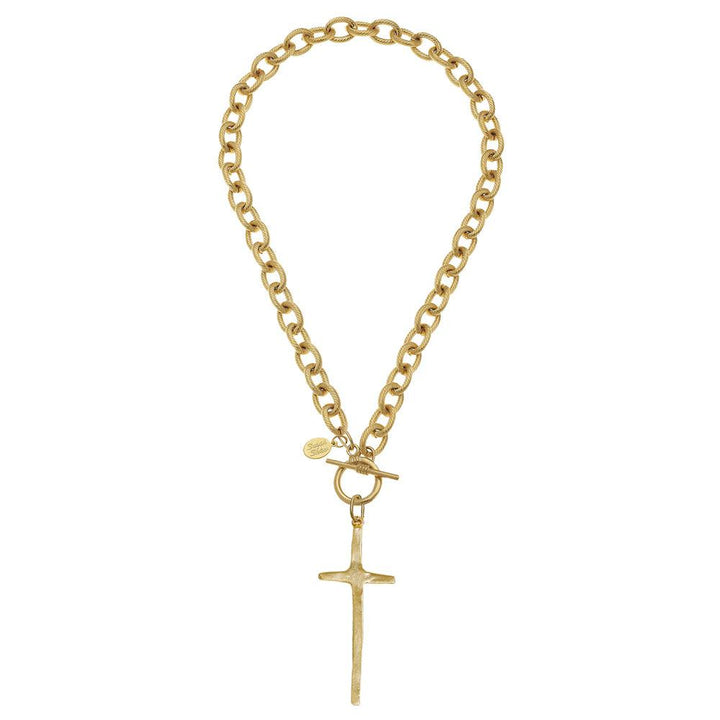 Gold cross pendant necklace with textured toggle clasp and chain.