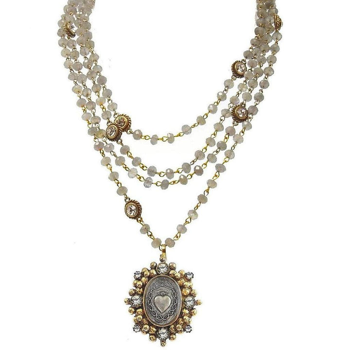 Layered labradorite bead necklace with ornate gold and silver pendant featuring a heart motif.