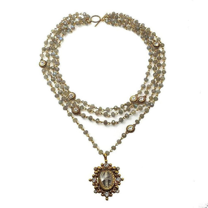 Layered labradorite and crystal necklace with ornate gold pendant.