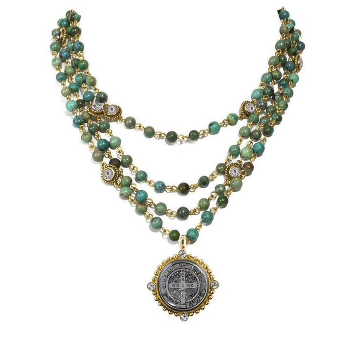 Three-strand turquoise bead necklace with gold accents and a detailed medal pendant.