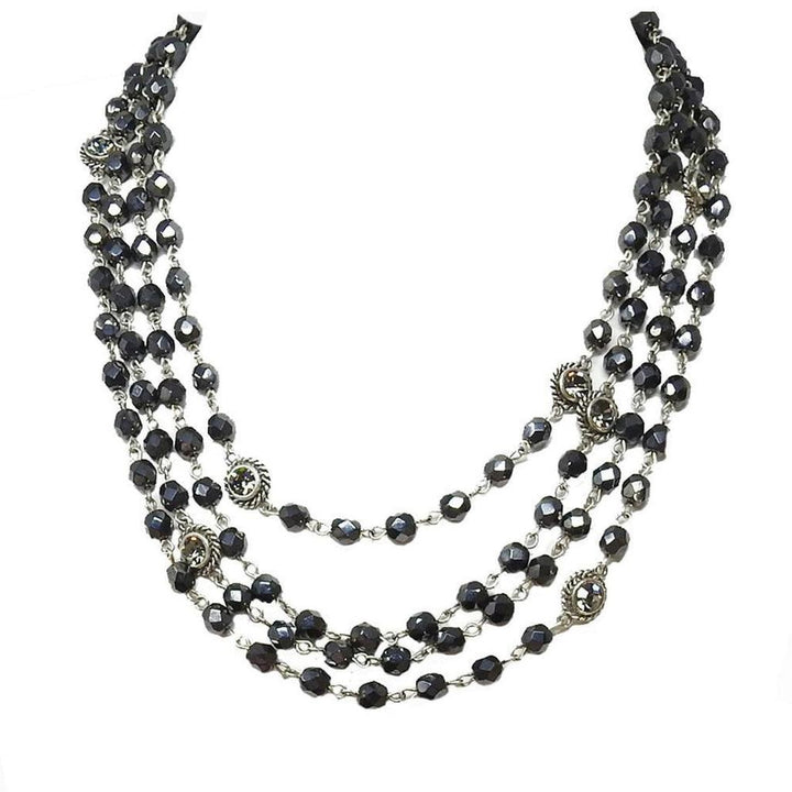 Multi-strand dark gray crystal necklace with silver accents.