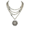Multi-strand silver necklace with smoky quartz beads and a detailed medallion pendant.