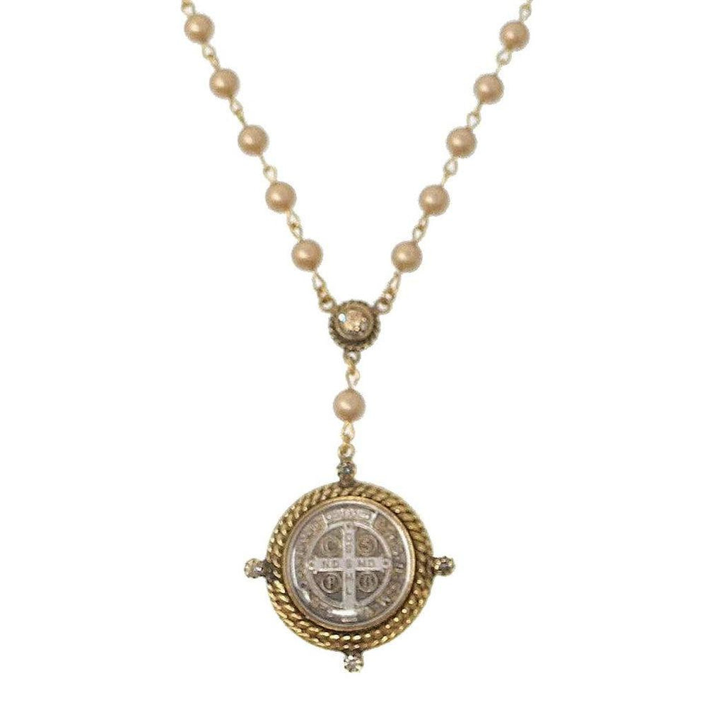 Elegant rosary necklace with creamy beads and ornate gold-toned medallion.