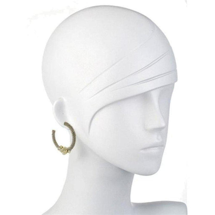 Beaded silver hoop earrings on a mannequin, showcasing detailed texture.
