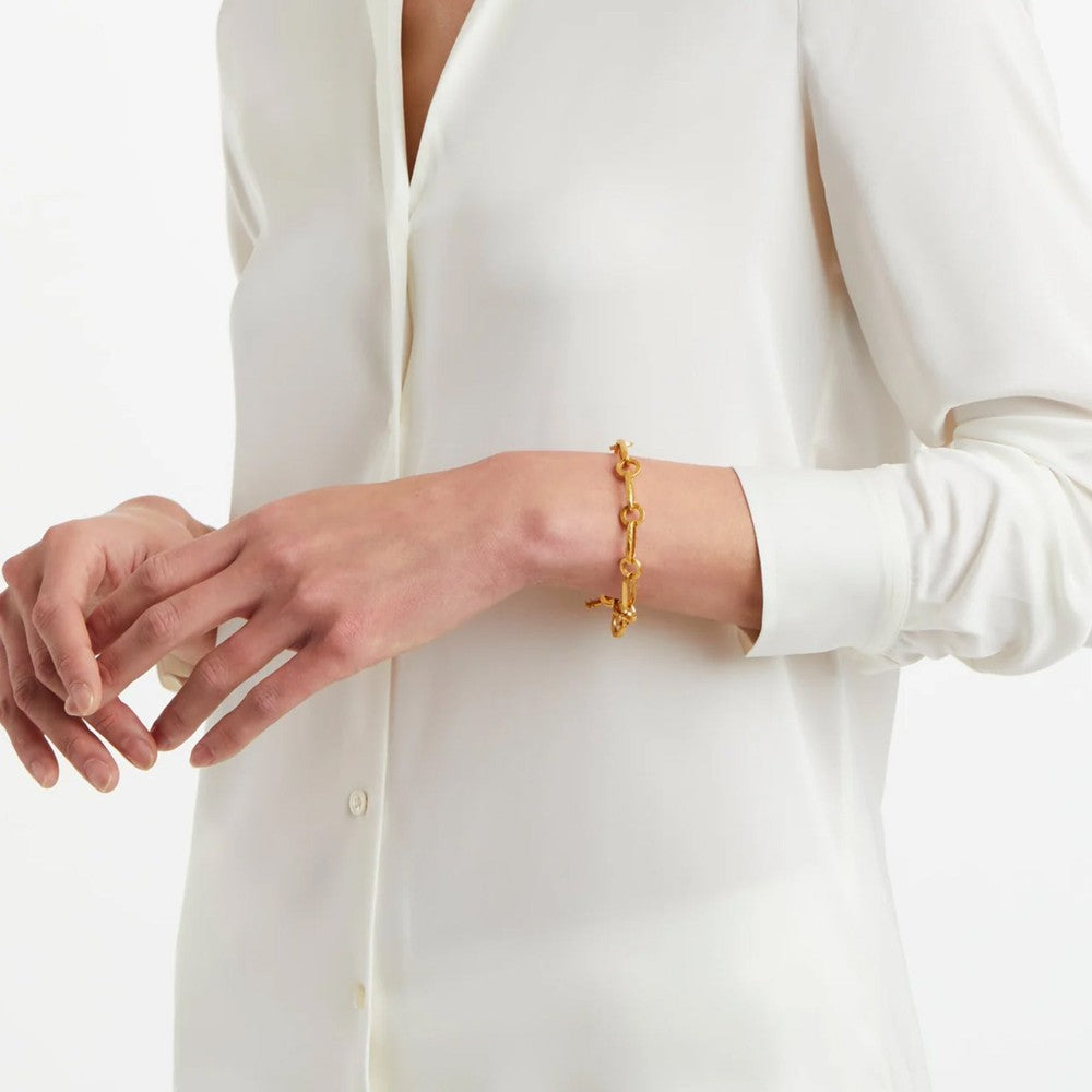 Gold chain bracelet on a wrist, detailed close-up.