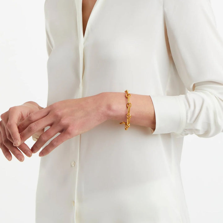 Gold chain bracelet on a wrist, detailed close-up.