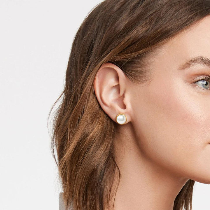 Gold stud earrings featuring a classic pearl design.