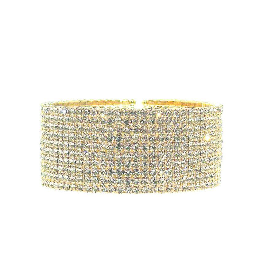 Gold bracelet with clear stones on a white background