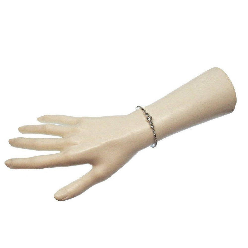 Delicate crystal cuff bracelet on a mannequin hand, showcasing its elegant design.
