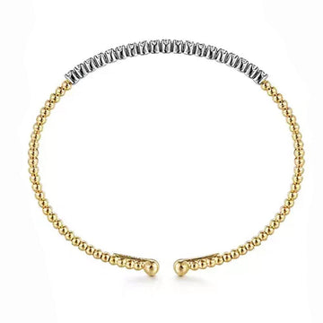 Beaded cuff bracelet in 14K gold with a diamond accent.
