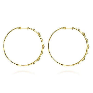 Large 14K yellow gold hoop earrings adorned with tiny diamonds.

