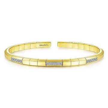 14k gold cuff bracelet featuring pave diamond accents.
