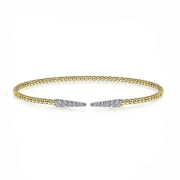 Beaded gold cuff bracelet accented with diamond pave spike details.
