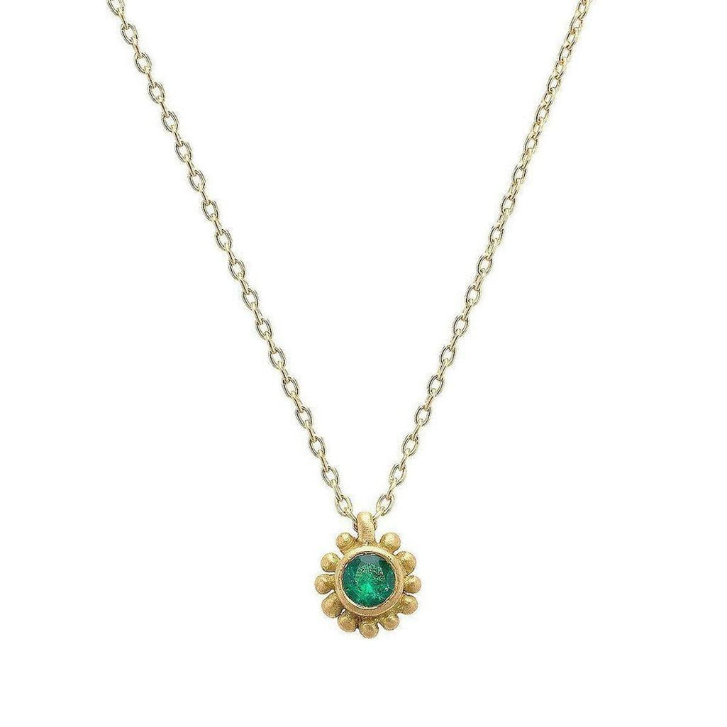 18k yellow gold necklace featuring a vibrant emerald gemstone in a delicate sunflower design.
