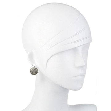 Silver hook earrings with ornate, circular design on a mannequin.
