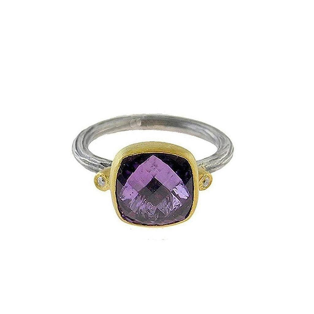 Amethyst ring with cushion-cut purple gemstone, accented by diamonds, in gold and silver setting.
