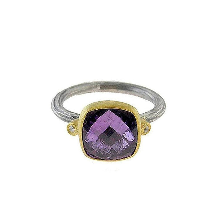 Amethyst ring with cushion-cut purple gemstone, accented by diamonds, in gold and silver setting.
