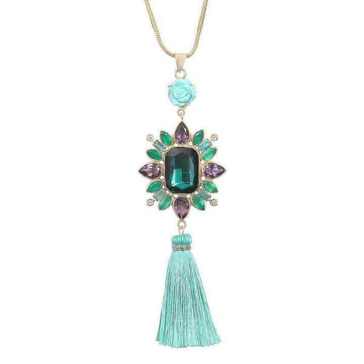 Amethyst & Turquoise Tassel Necklace:  Gold chain, large emerald green gemstone, purple & green accents, turquoise tassel.
