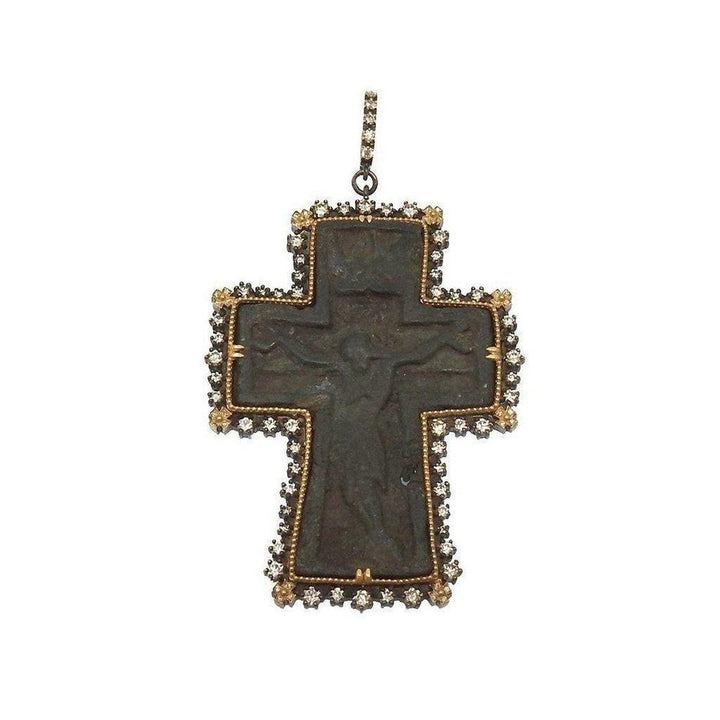 Ancient Russian cross pendant with diamond bezel; dark metal, detailed crucifix.
