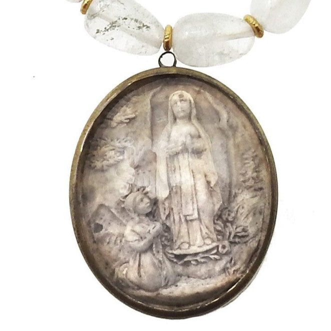 Antique Carved Icon of St. Anne necklace: Clear quartz beads & bronze oval pendant featuring St. Anne & child.
