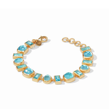 Gold bracelet featuring a mosaic of light blue gemstones in various shapes.
