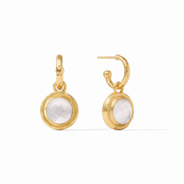 Gold hoop earrings with a dangling white gemstone charm.
