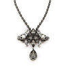 Auden Duval Pendant: Silver necklace with gray crystal skulls & teardrop pendant.

