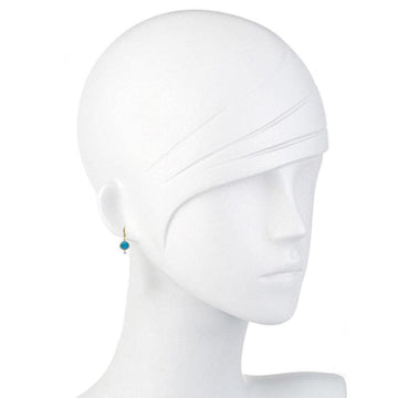 Elegant turquoise earrings on a mannequin, showcasing the vibrant stone and gold setting.

