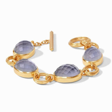 Gold bracelet featuring gray gemstones, toggle clasp.
