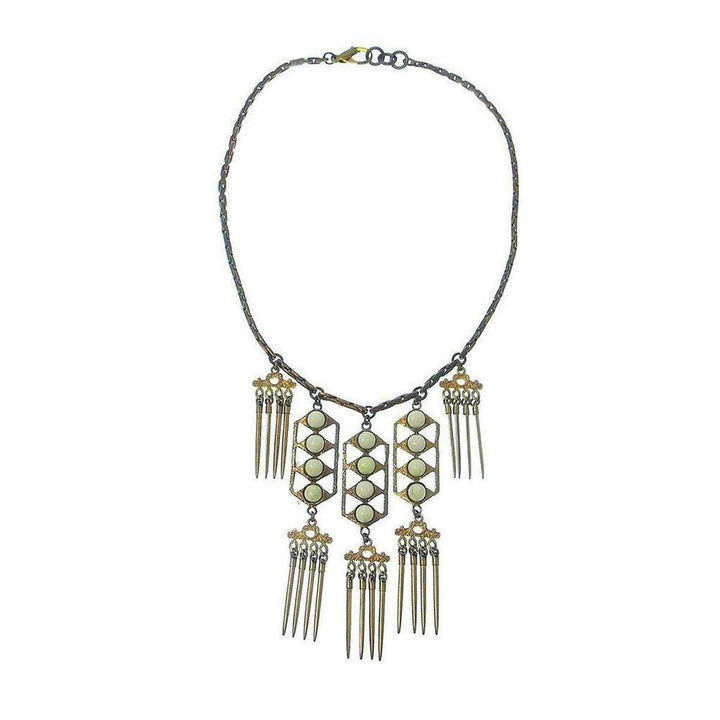 Beachcomber necklace: gold & bronze chain, off-white stones, geometric pendant with fringe accents.
