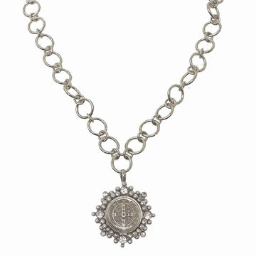 Silver chain necklace featuring a circular pendant with clear stones.
