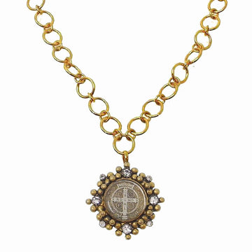 Gold chain necklace featuring a circular antique-style medal pendant accented with sparkling stones.
