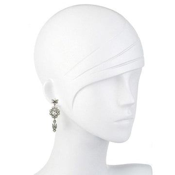 Crystal drop earrings on a mannequin, showcasing sparkling detail.
