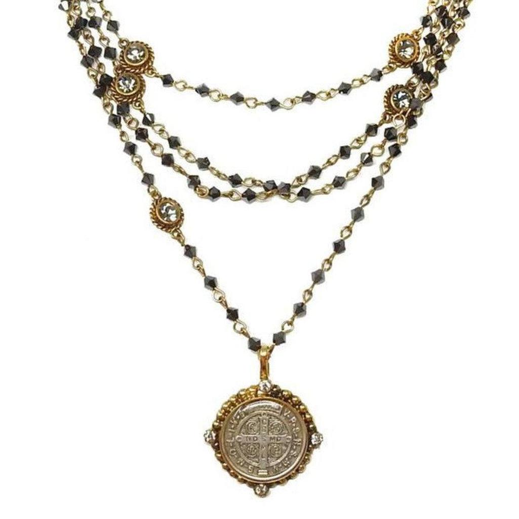 Bicone Magdalena Gold Hematite necklace: layered black hematite beads, gold accents & St. Jude medal.
