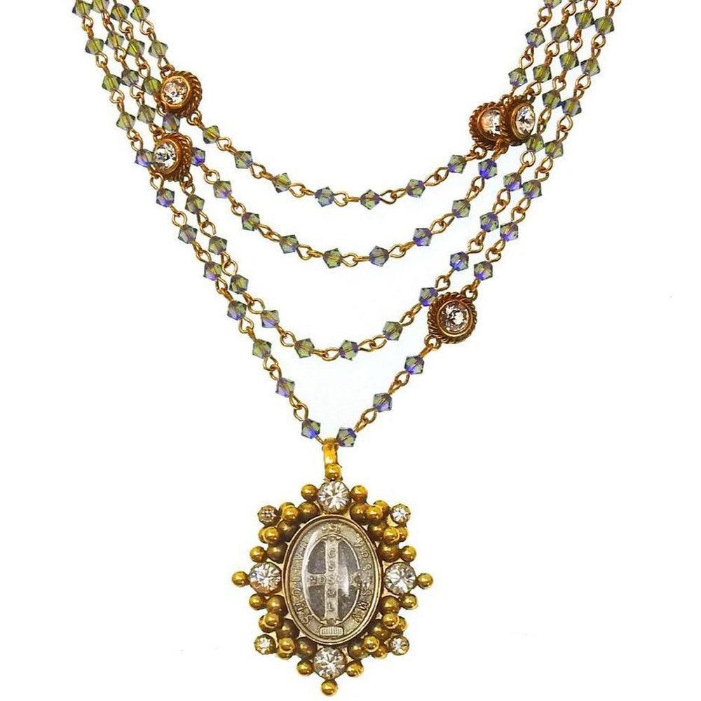 Layered gold necklace featuring iridescent beads and a detailed antique-style pendant.
