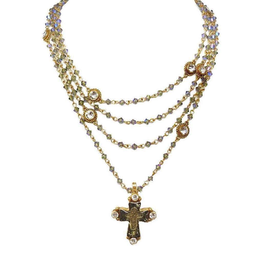 Multi-strand necklace with iridescent beads, gold accents, and a cross pendant.
