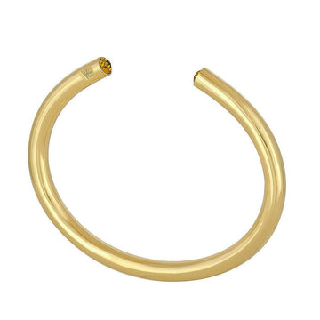 Gold bangle bracelet with gemstone accent.
