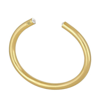 Gold cuff bracelet featuring small pearl accents.

