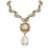 Elegant Blue Nile statement necklace with pearlescent and gold accents.
