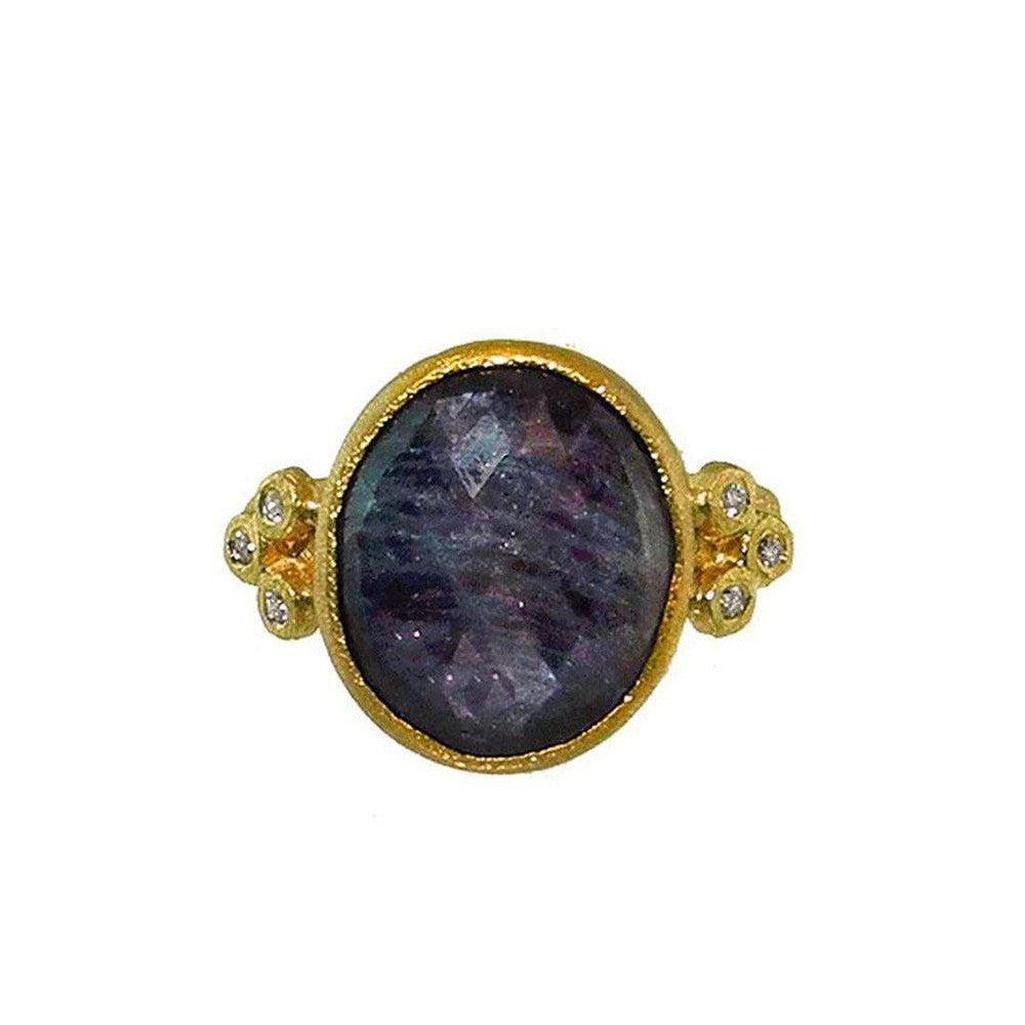Oval blue sapphire ring in 18k gold with diamond accents
