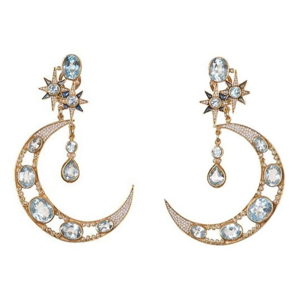 Crescent moon blue topaz earrings with star accents; gold-tone setting.
