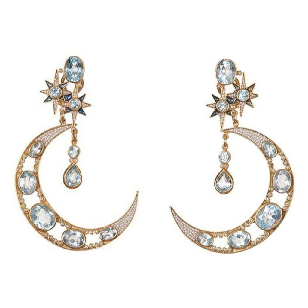 Crescent moon blue topaz earrings with star accents; gold-tone setting.
