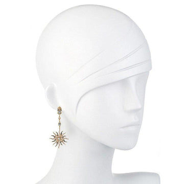 Elegant sunburst earrings featuring blue topaz and pearls, displayed on a mannequin.
